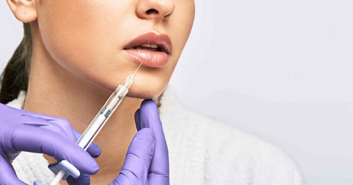 Close-up of lip enhancement in Myrtle Beach, SC by a professional with purple gloves.